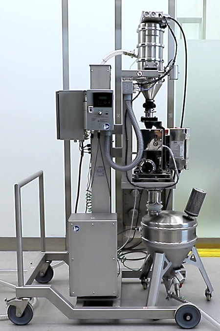 Mobile lifting column with a vacuum conveyor and a metal detector. The system enables the powder to be checked for metallic foreign bodies, e.g. directly before filling a packaging machine.